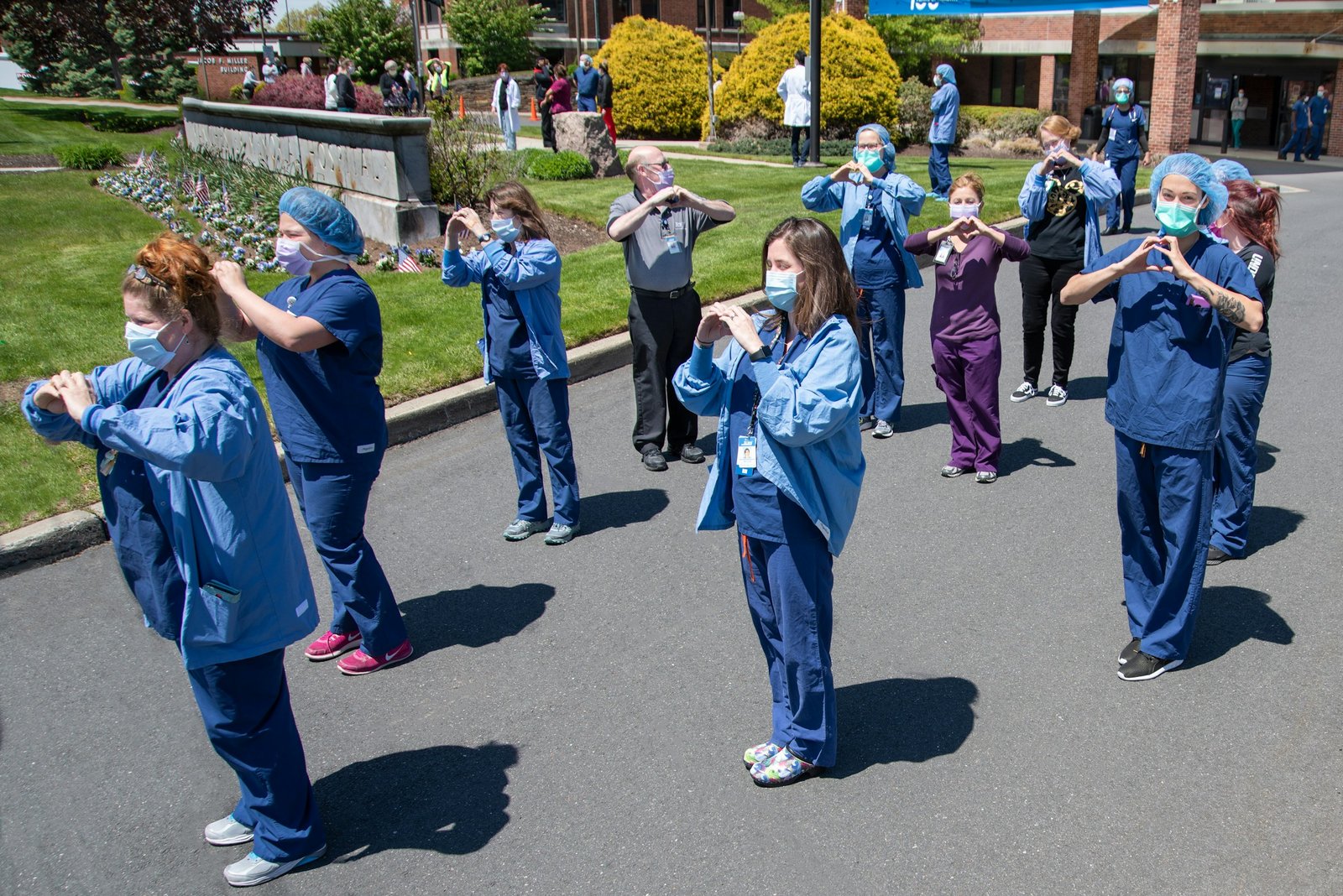 A clinical team standing together outside a healthcare facility